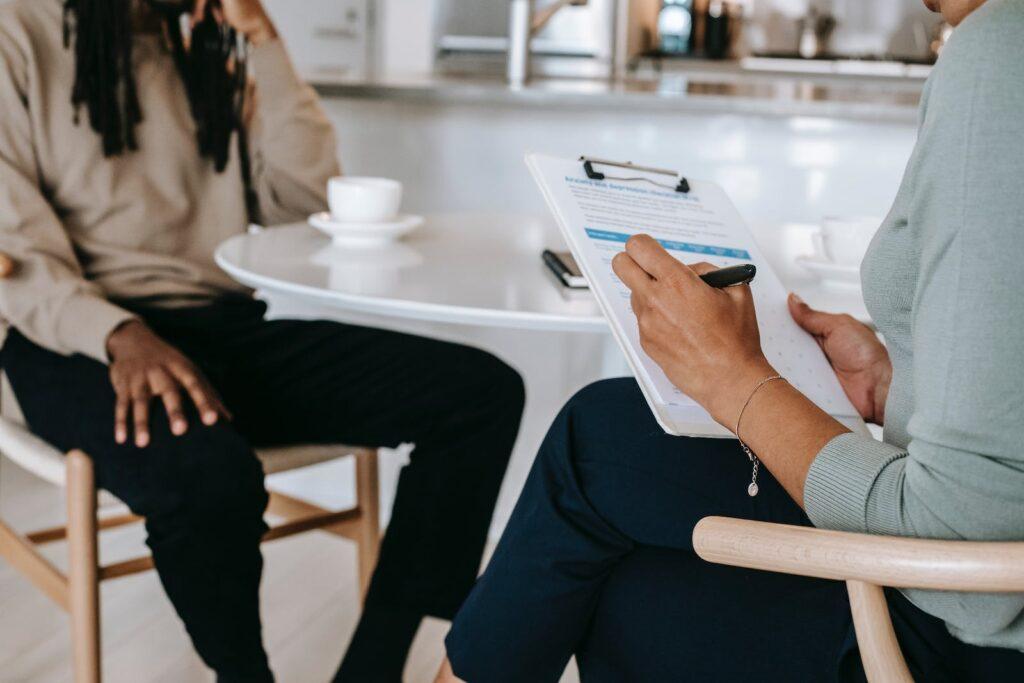 Crop faceless multiethnic interviewer and job seeker going through interview